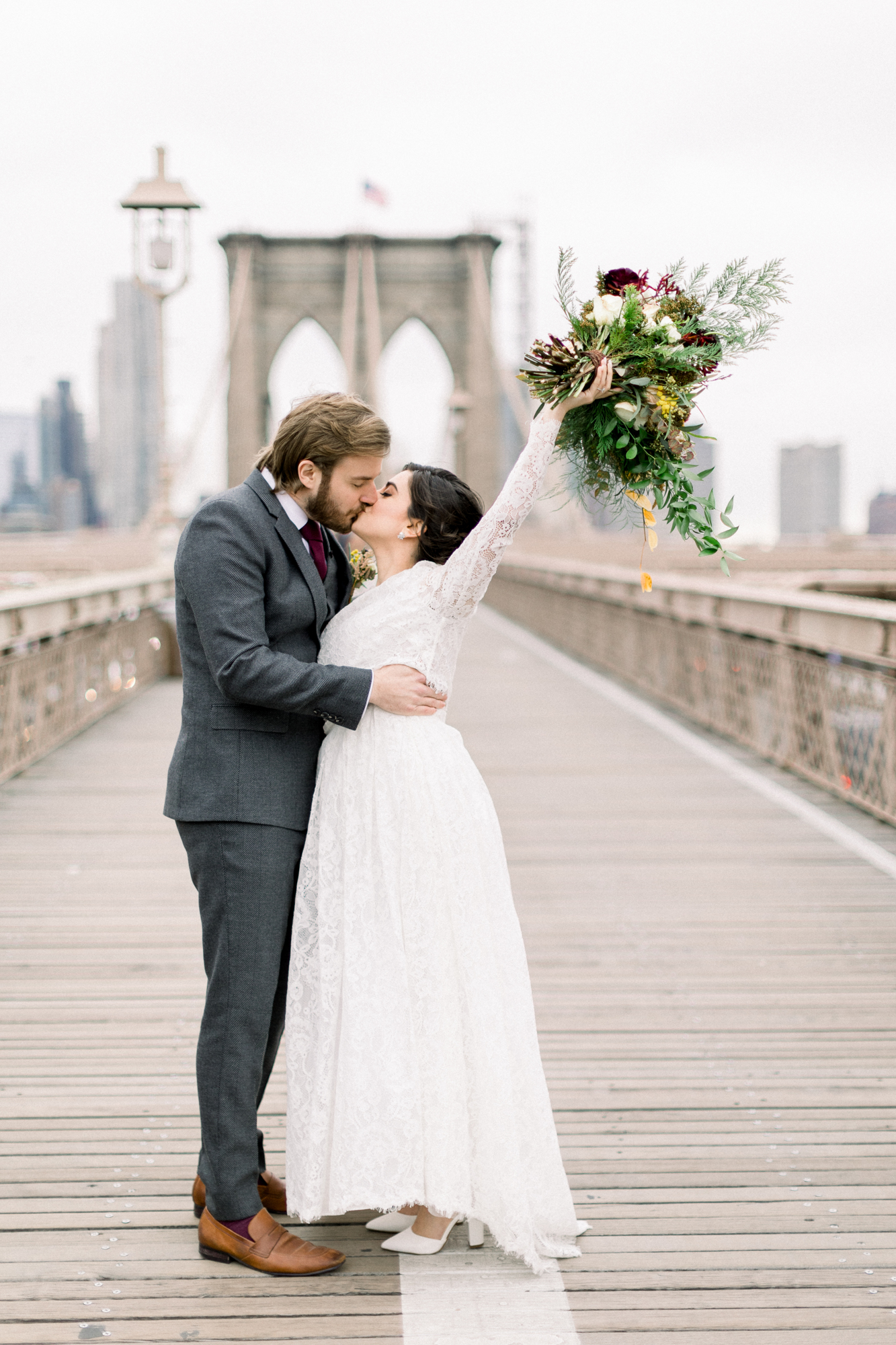 Rainy elopement photos on the Brooklyn Bridge