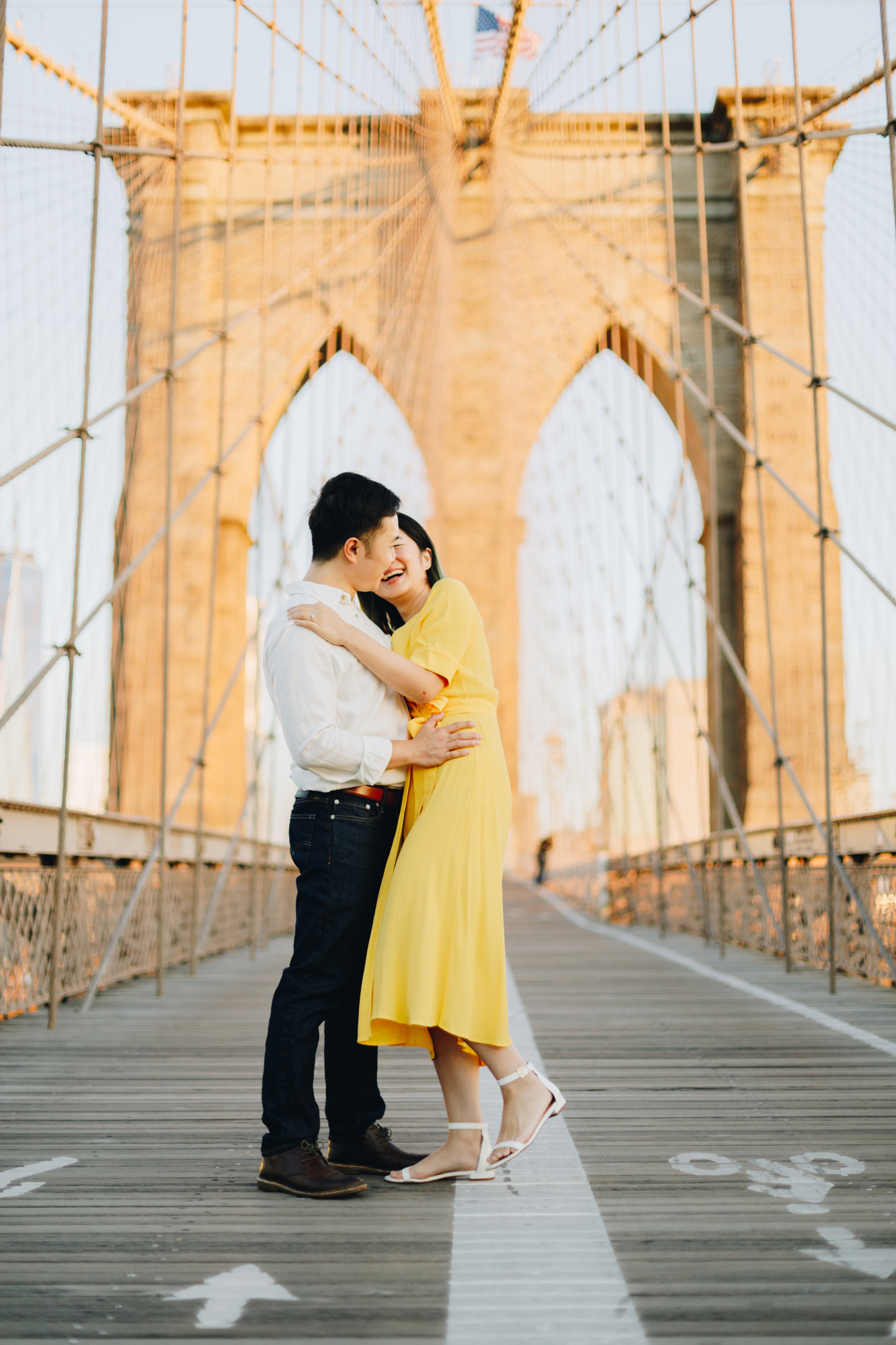 Sunrise engagement photo at the Brooklyn Bridge with yellow dress