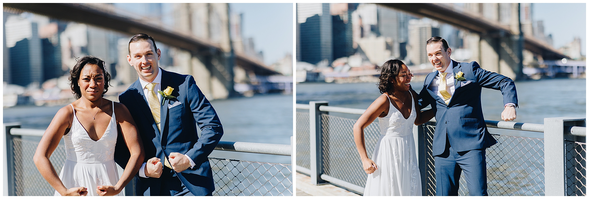A bride and groom in wedding attire stand by a waterfront railing, playfully flexing their arms and making funny faces, capturing the joyful spirit of a Wagner Cove elopement with a cityscape and bridge in the background.