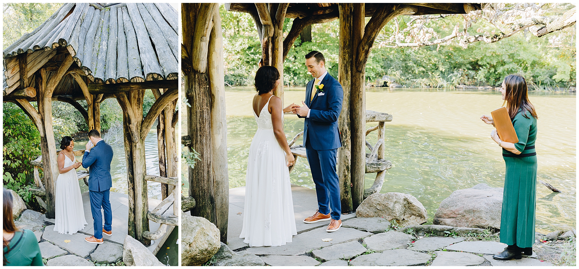 A couple stands under a rustic wooden gazebo by a lake, exchanging rings during their Wagner Cove elopement, while an officiant in a green dress stands nearby holding a folder.