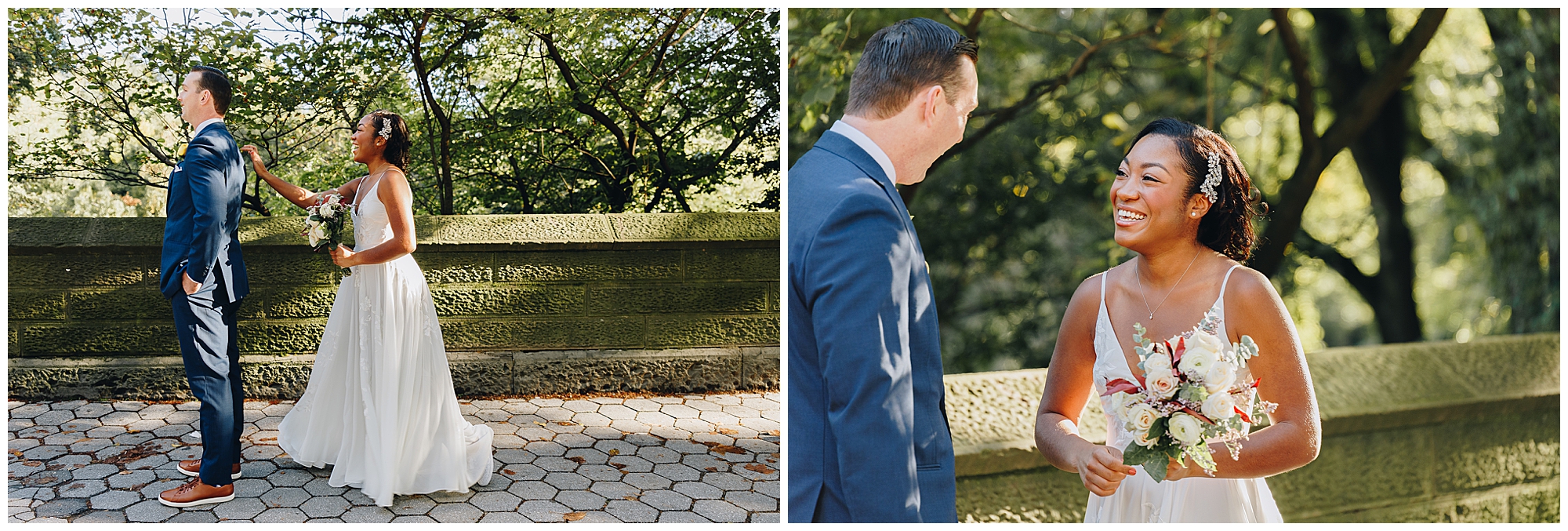 A bride and groom share a joyful first look outdoors during their Wagner Cove elopement. He wears a blue suit, she is in a white dress holding a bouquet. Sunlight filters through trees as they smile and face each other by a stone wall.