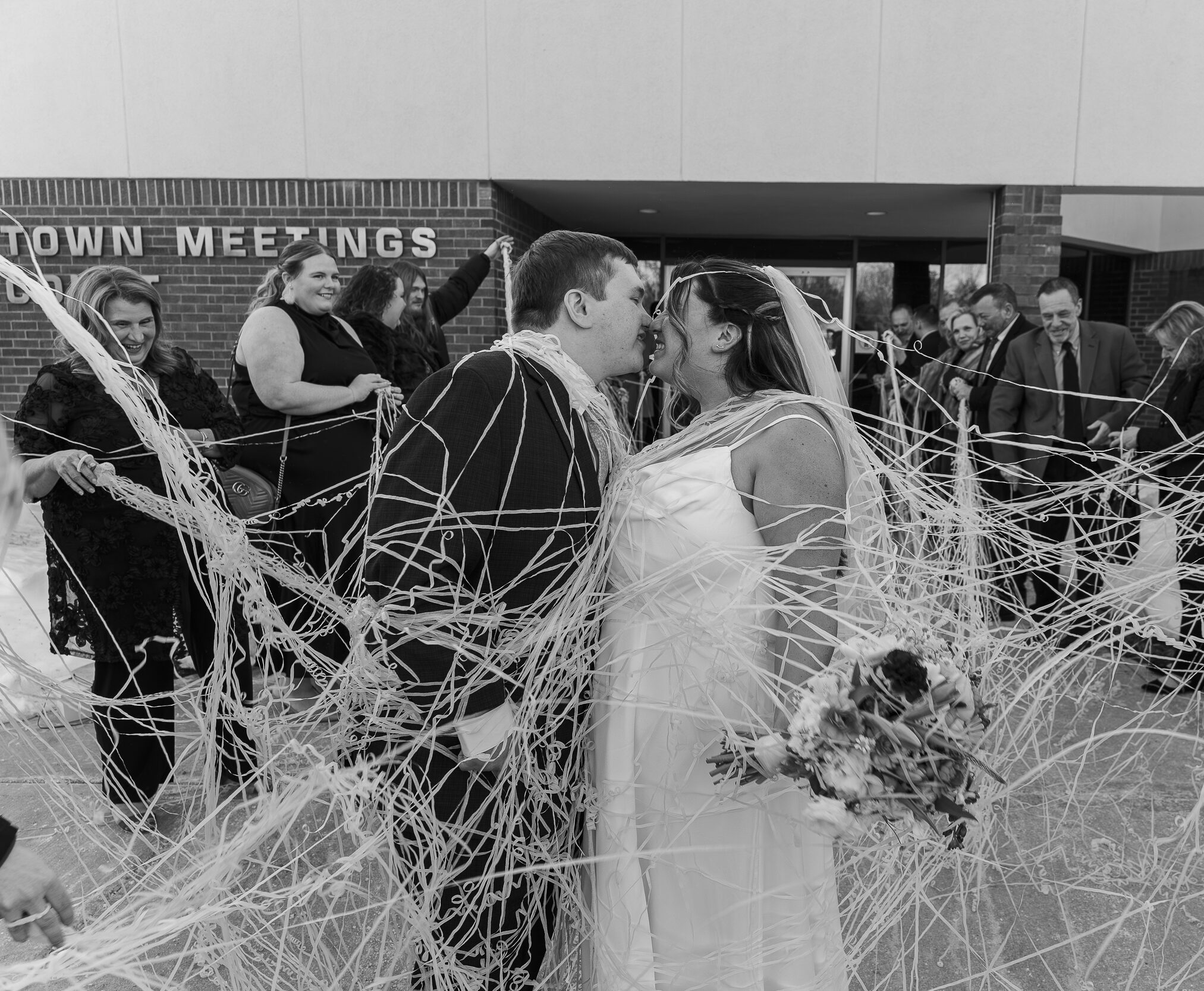 Groom helping bride with jacket before winter City Winery reception photos