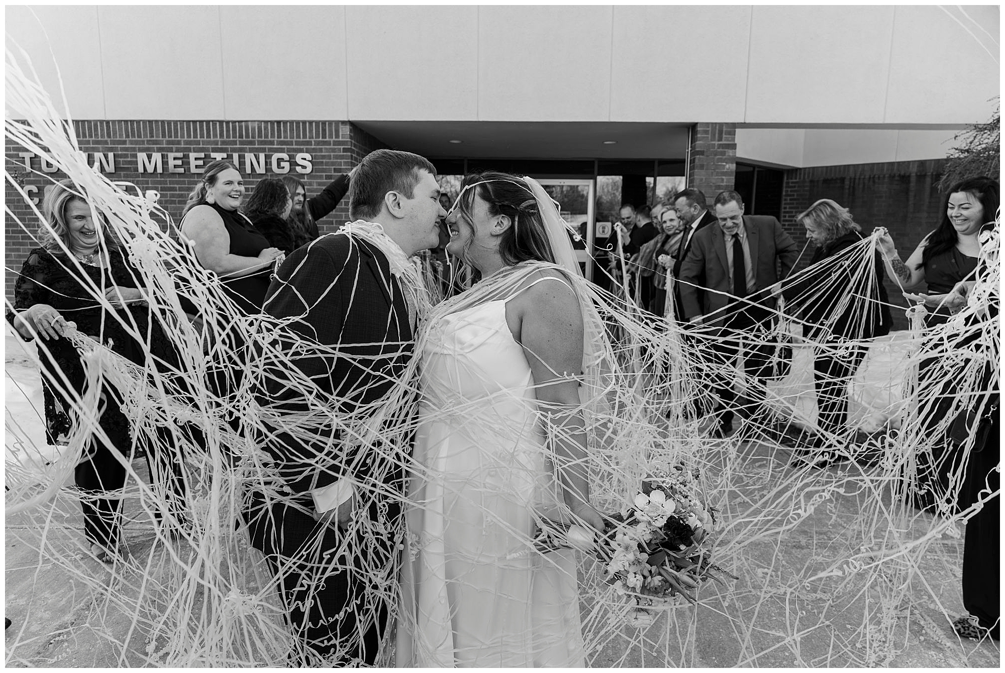 Couple laughing together during winter courthouse wedding portraits