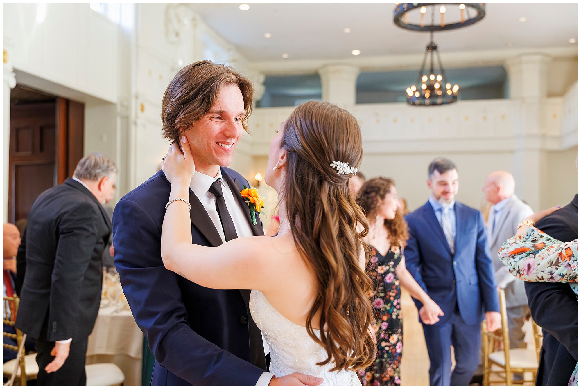 Happy newlyweds dancing together at their indoor wedding reception, captured by Hudson Valley wedding photographers specializing in wedding photography and videography
