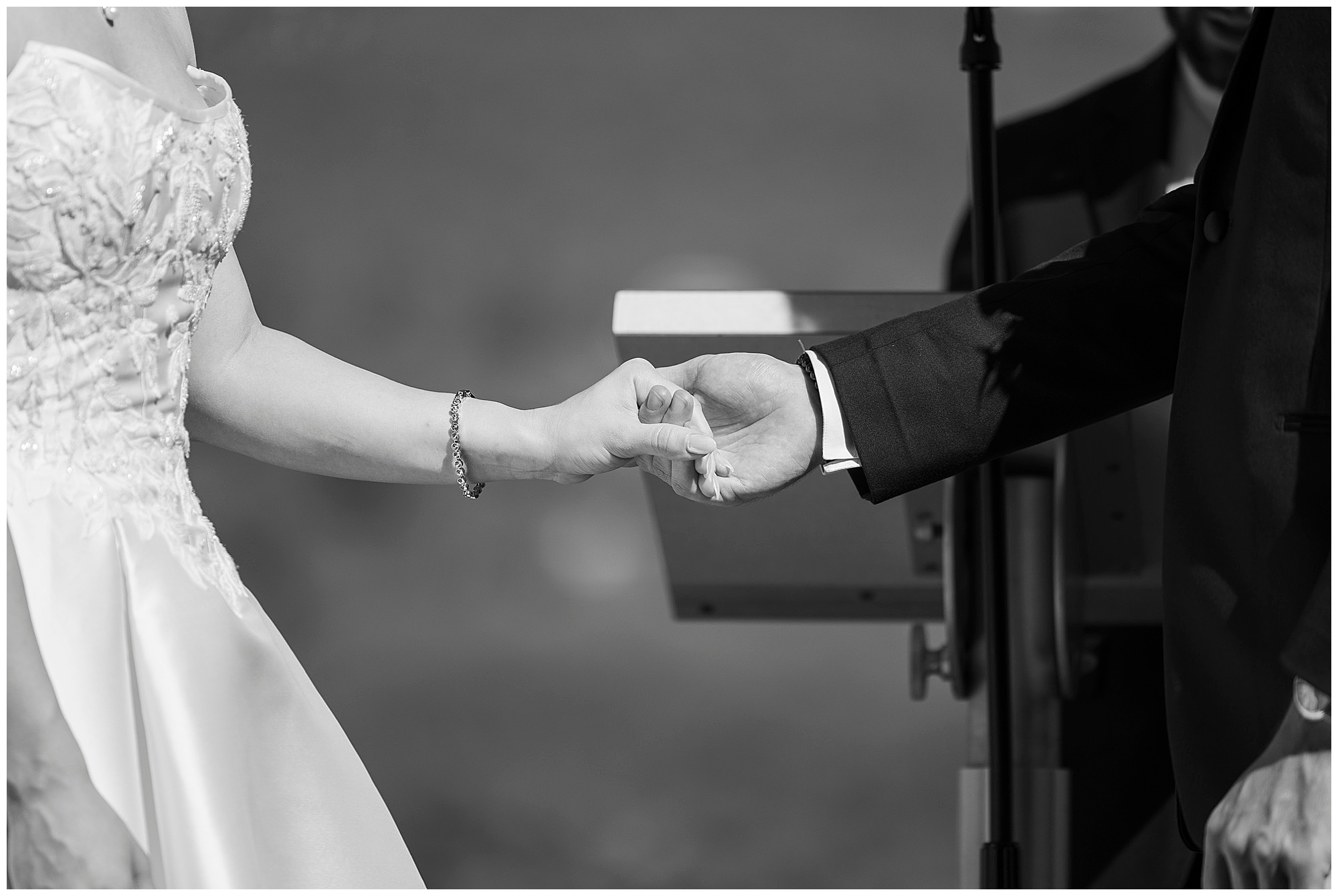 Black and white photo of ring exchange during the wedding ceremony at The Thayer Hotel at West Point