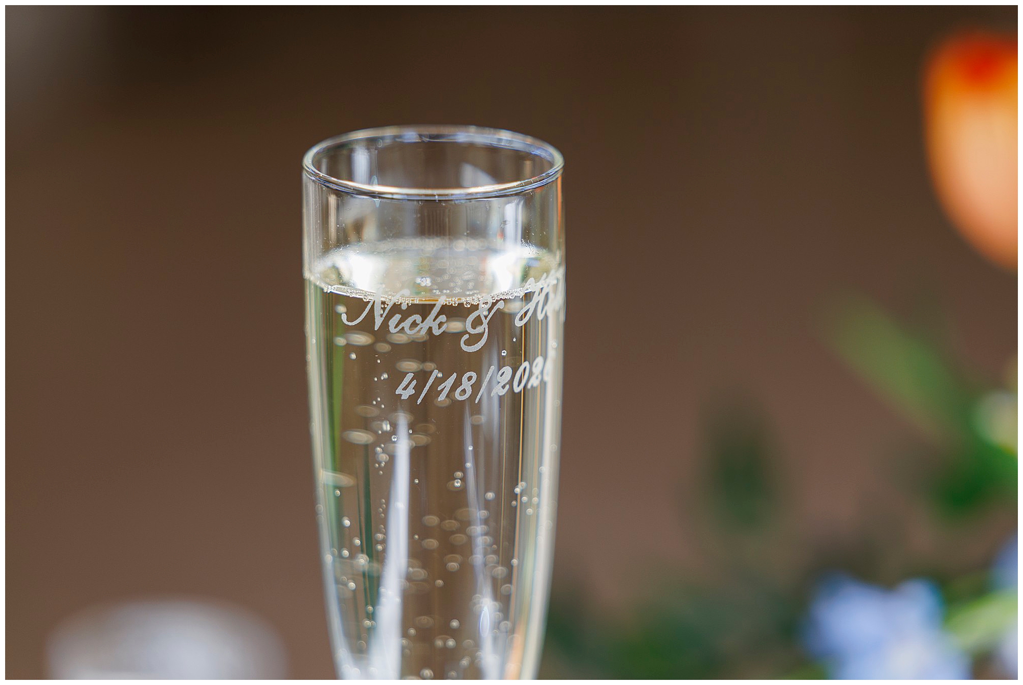 Personalized champagne flute with engraved names and wedding date, captured by Hudson Valley wedding photographers specializing in romantic celebration details and memories