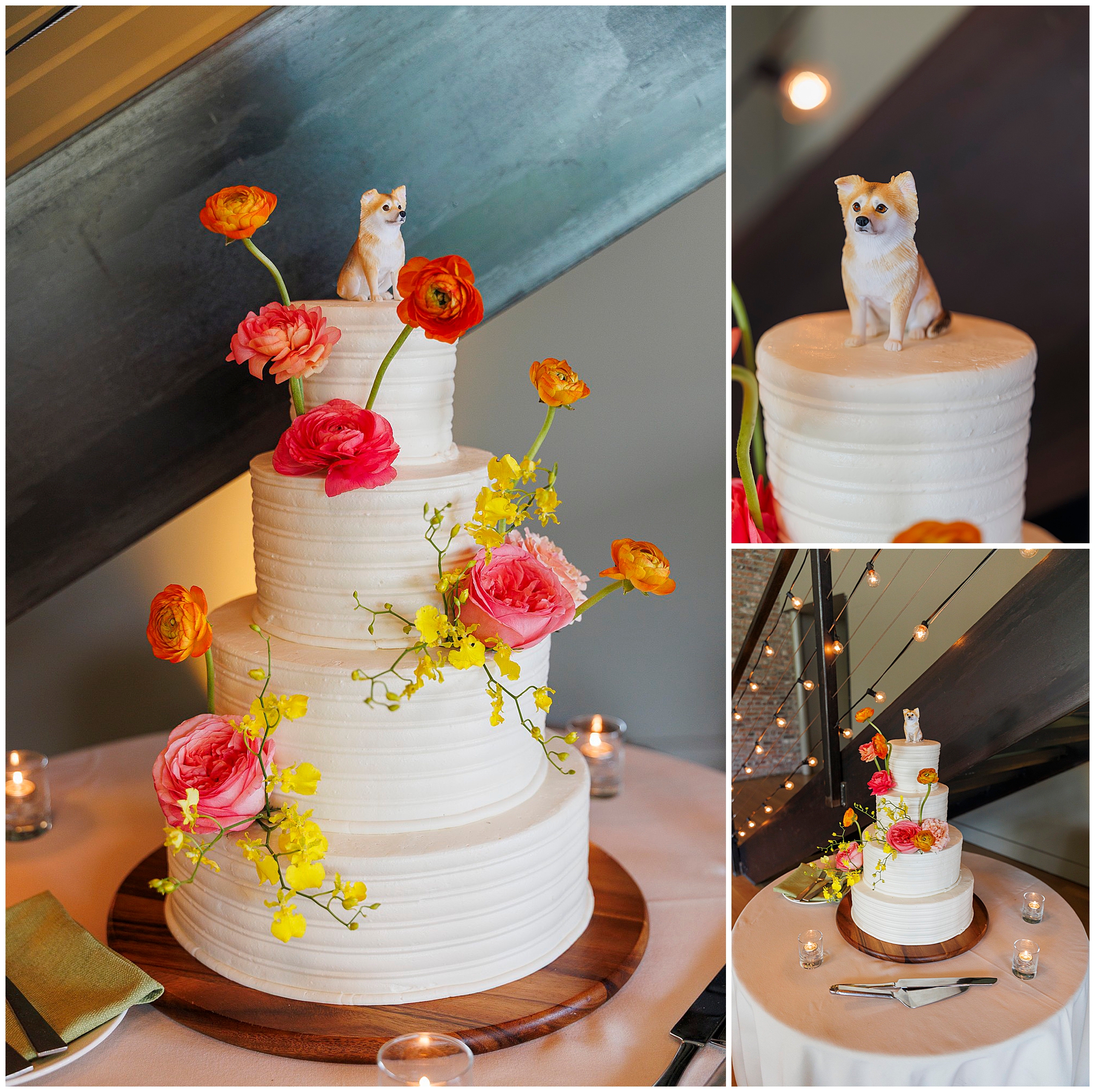 A three-tiered white wedding cake decorated with pink, orange, and yellow flowers sits on a wooden stand at this roundhouse wedding. Topped with a small dog figurine, the cake is surrounded by small candles on the table.
