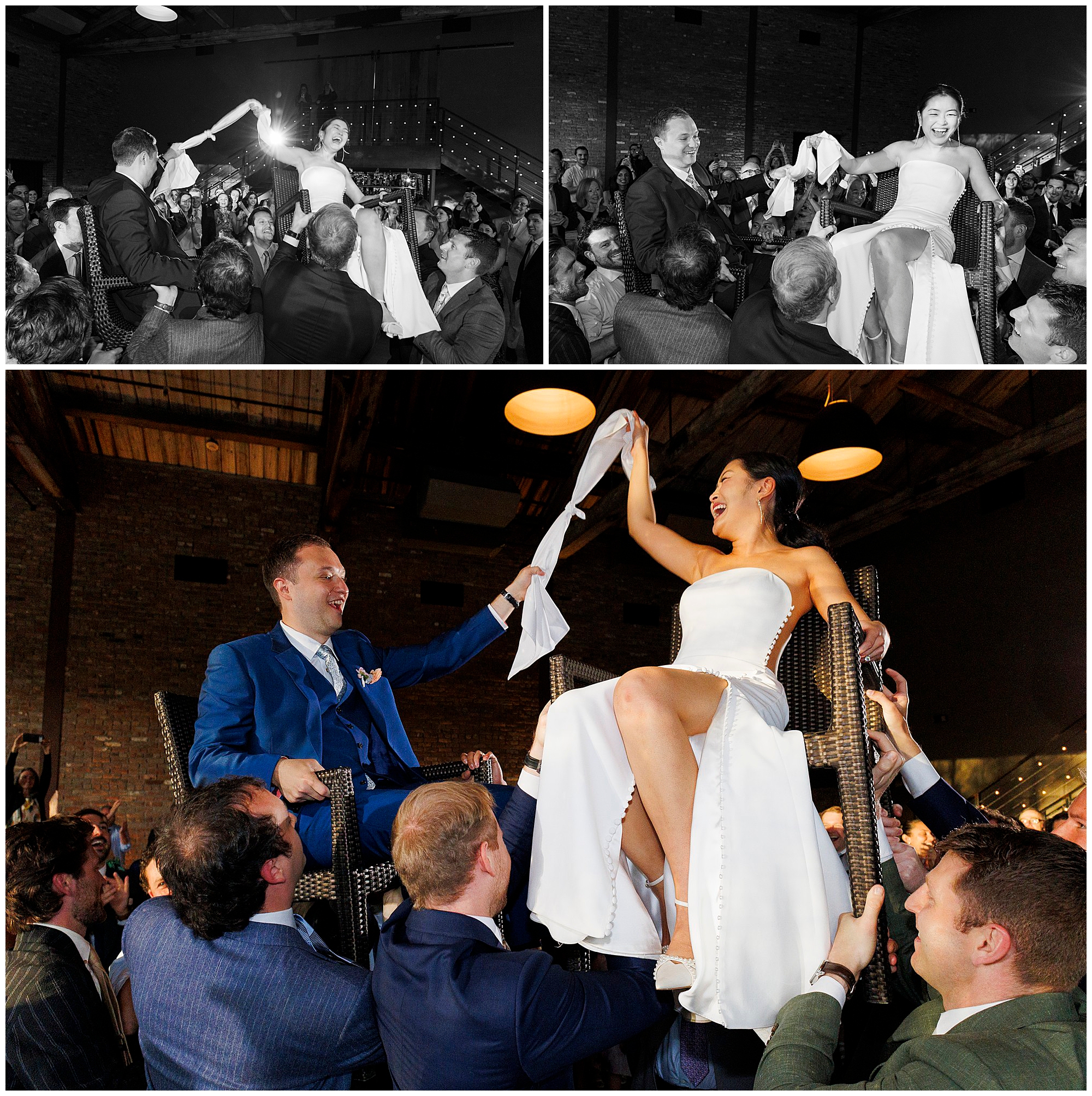 A bride and groom are lifted on chairs by guests during a roundhouse wedding celebration. They smile and hold a white cloth between them, surrounded by cheering friends in a lively indoor venue with wooden ceilings.