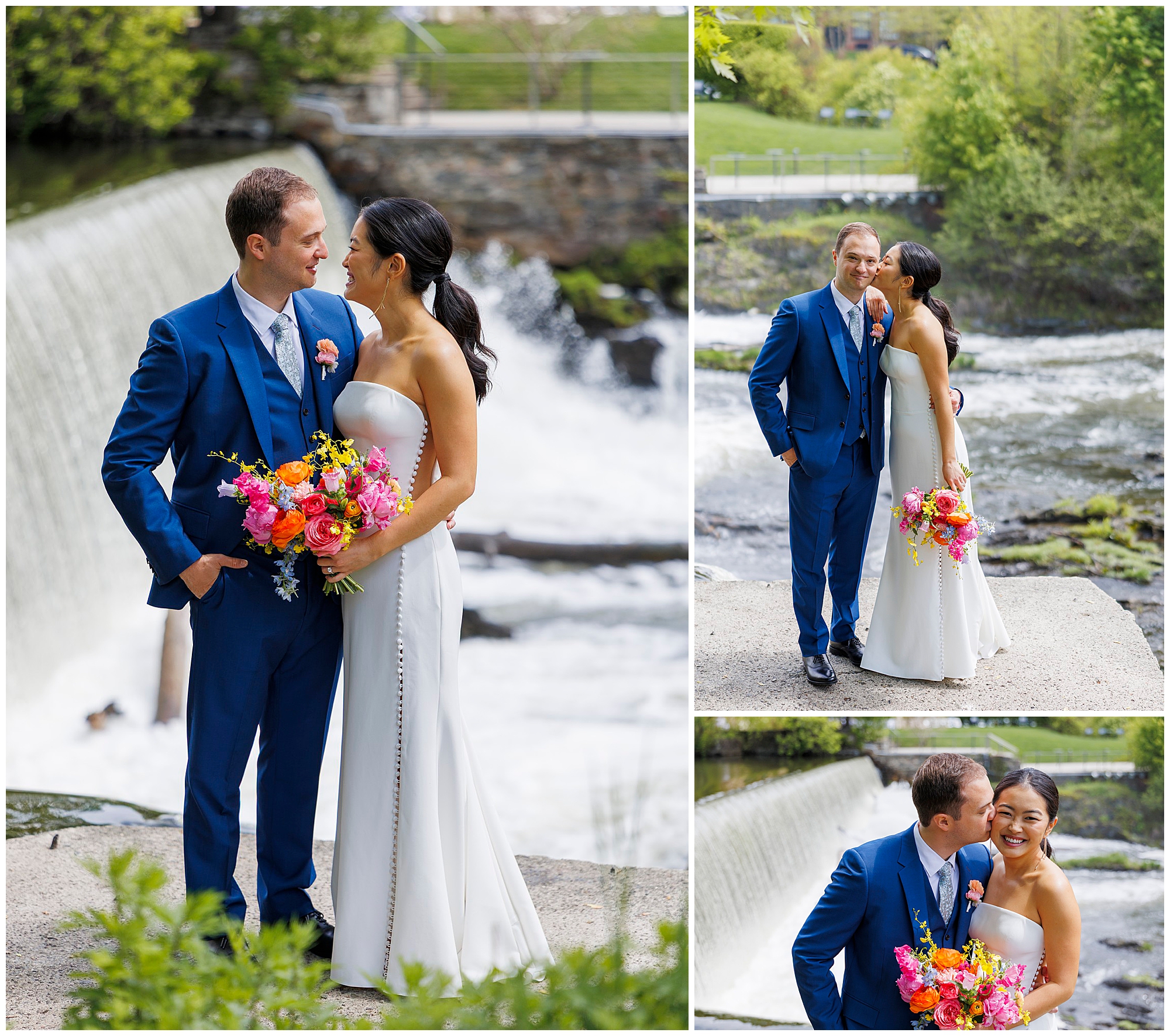 A bride in a white dress and groom in a blue suit stand by a waterfall at their roundhouse wedding, smiling and holding a colorful bouquet as they share joyful, affectionate moments outdoors.