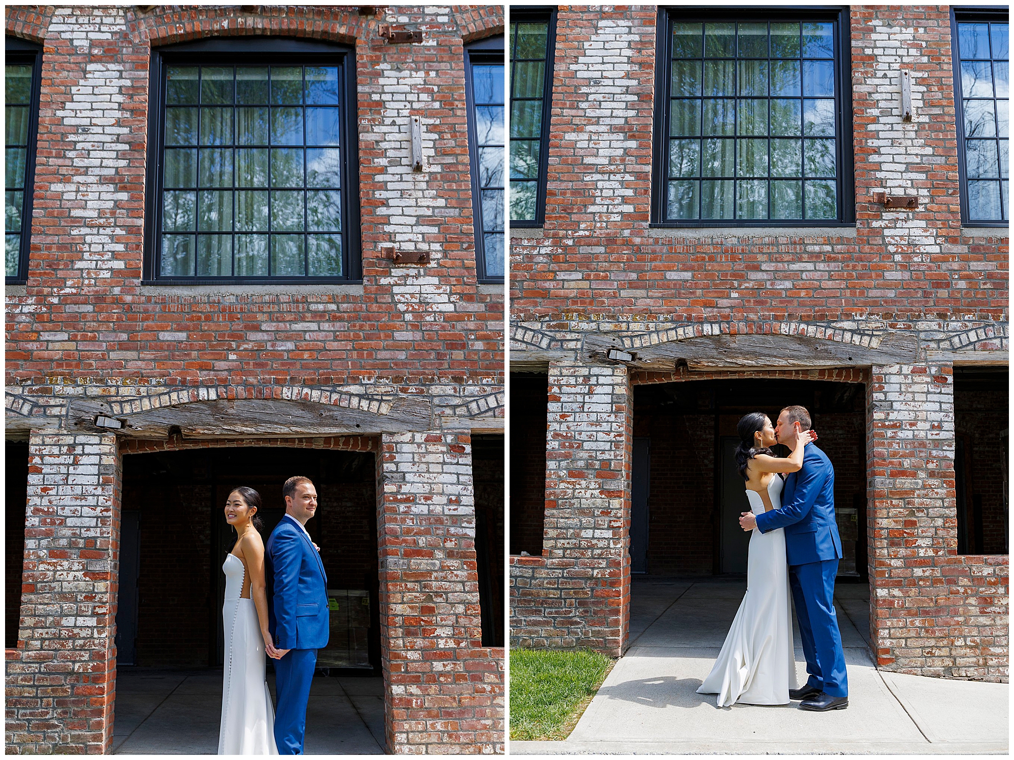 A bride in a white dress and a groom in a blue suit stand back-to-back, then embrace in front of the roundhouse wedding venue’s striking brick building with large windows.