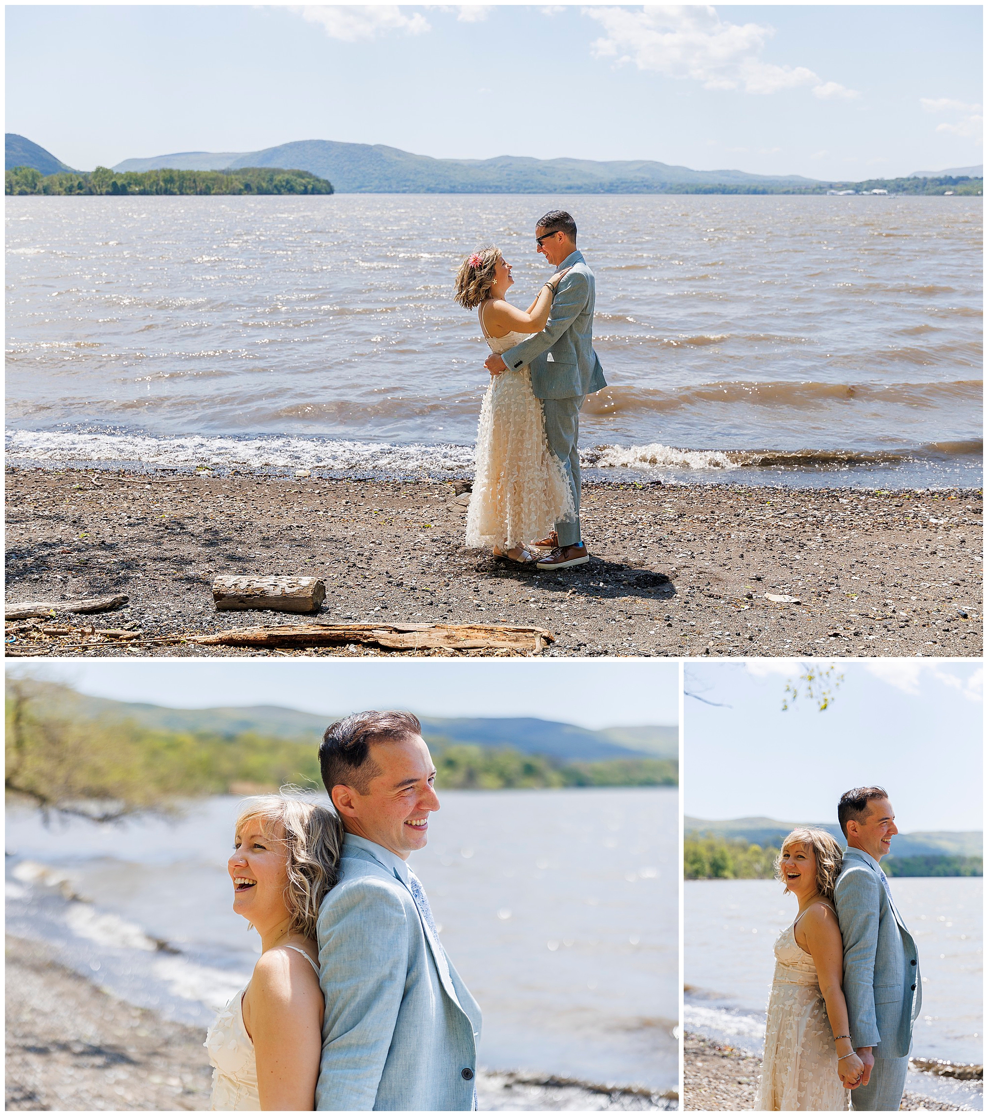 A couple in wedding attire poses by a lake with mountains in the background, their joyful embrace capturing the spirit of a Beacon Courthouse elopement as they stand back-to-back, smiling under a bright, sunny sky on a rocky shoreline.