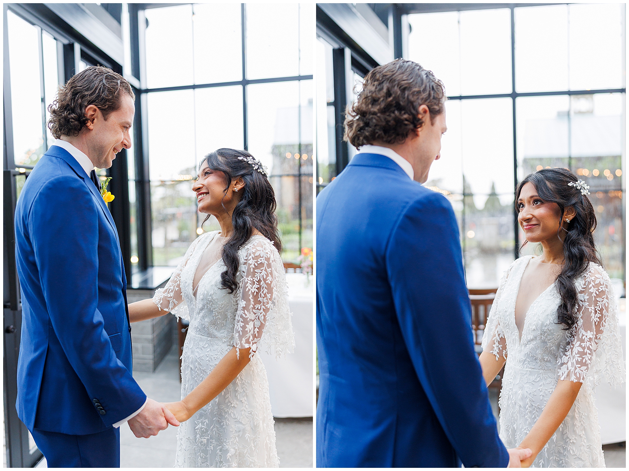 A bride and groom stand indoors at their Harvest on Hudson micro wedding, holding hands and smiling warmly at each other. The bride wears a white lace dress, the groom is in a blue suit, and large windows provide natural light in the background.