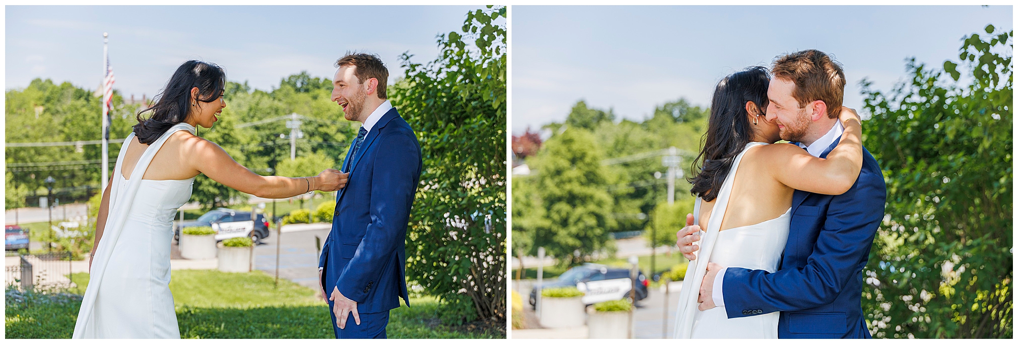 A bride in a white dress surprises her groom in a blue suit during their Beacon City Hall elopement; she playfully tugs his tie, then they embrace and kiss joyfully, surrounded by lush greenery outdoors.