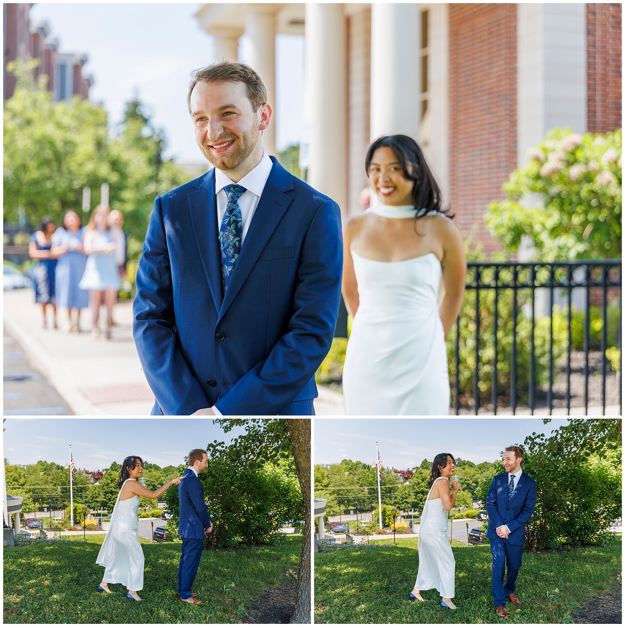A bride in a white dress walks up behind a smiling groom in a blue suit for their first look outdoors at their Beacon City Hall elopement, with bridesmaids watching nearby and lush greenery surrounding them.