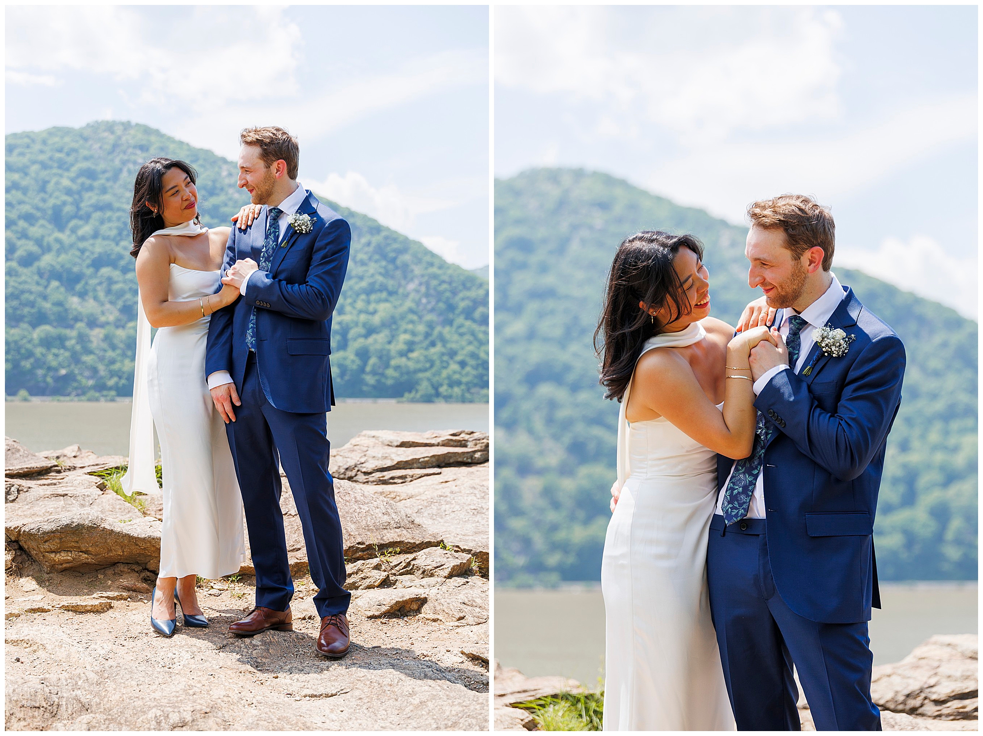 A bride and groom stand outdoors on rocky ground by a lake with a forested mountain in the background, smiling and holding each other closely in wedding attire after their Beacon City Hall elopement.
