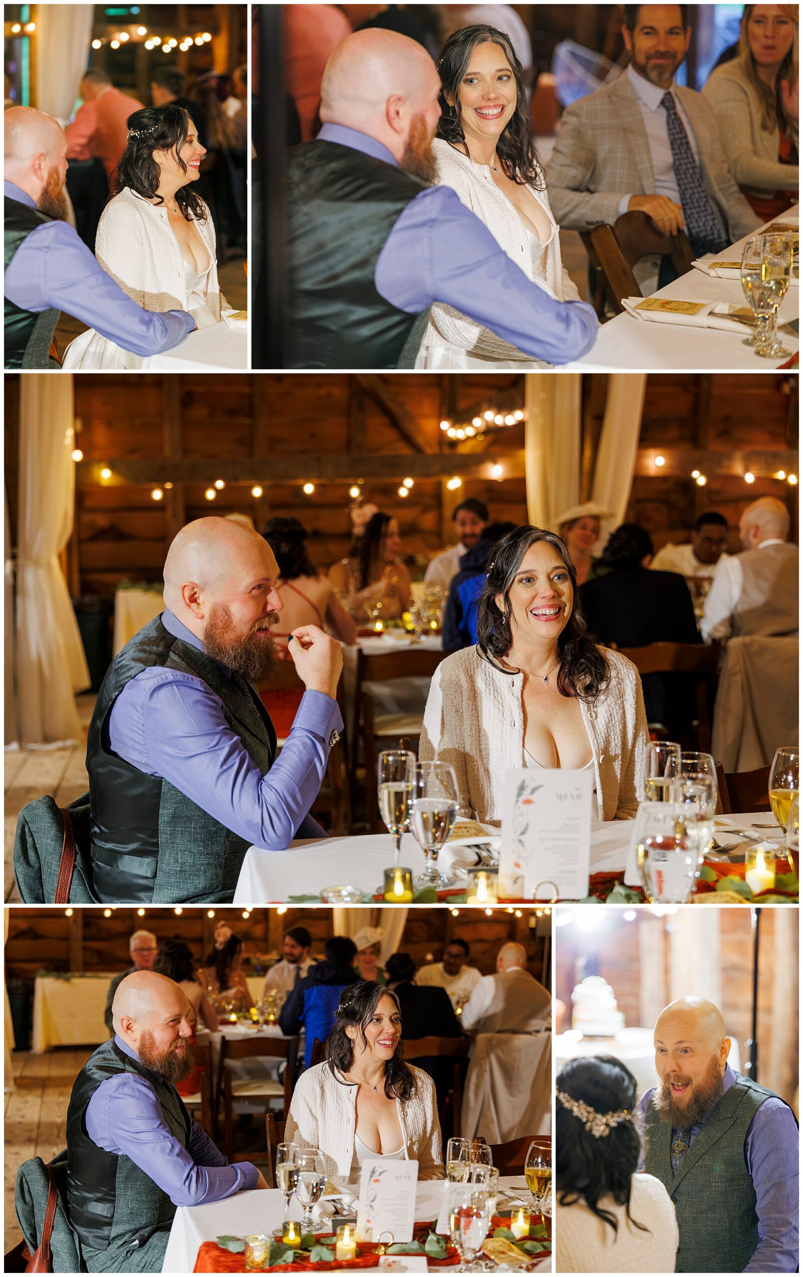 A man and woman sit together at a decorated table during a festive indoor event, smiling and talking with guests under warm string lights. Other attendees dine and converse around them in a cozy, rustic setting.