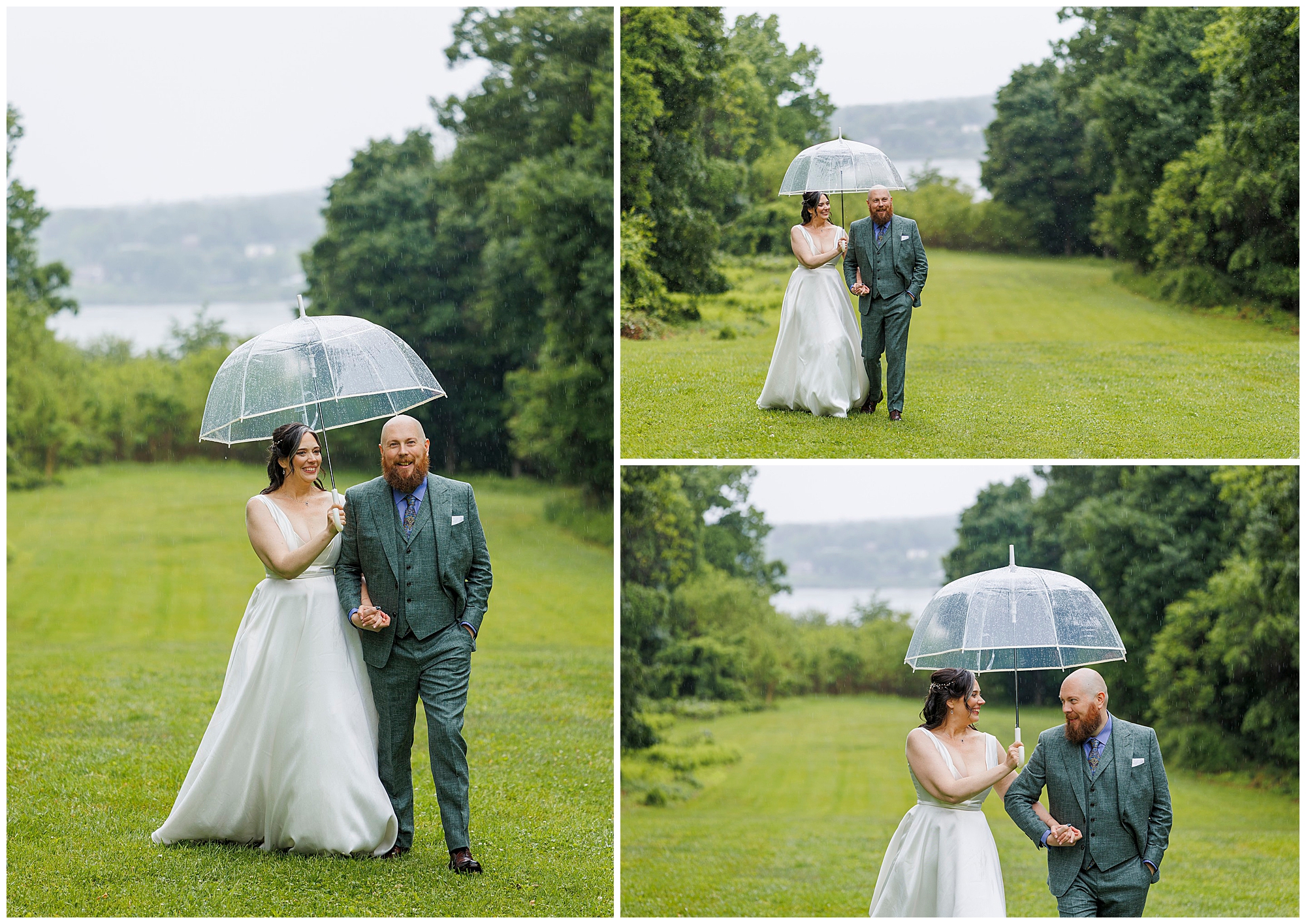 A bride and groom walk together on a grassy path, sharing a clear umbrella on a rainy day. The bride wears a white dress, and the groom wears a green suit. Trees and a river are visible in the background.