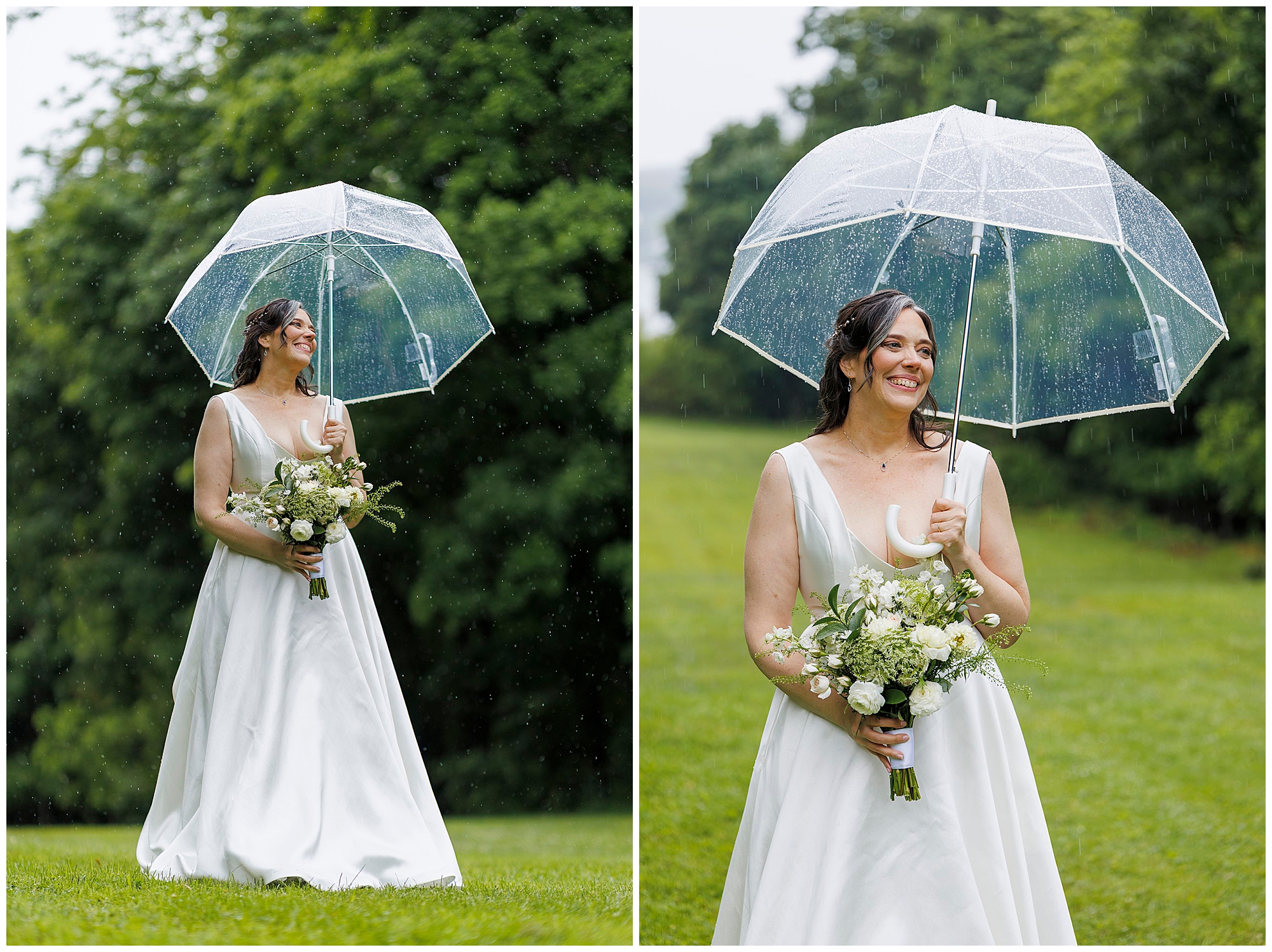 A bride in a white dress stands outdoors in the rain, holding a clear umbrella and a bouquet of white flowers. She smiles, surrounded by lush green trees and grass.