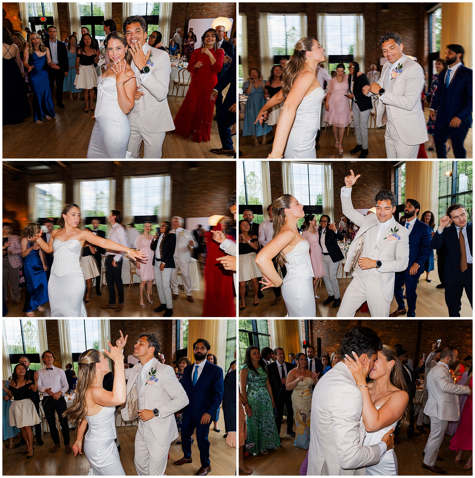 A couple in white wedding attire joyfully dances at their reception, surrounded by guests on a lively dance floor in a bright, elegant venue—perfect for capturing stunning wedding photos at the Roundhouse.