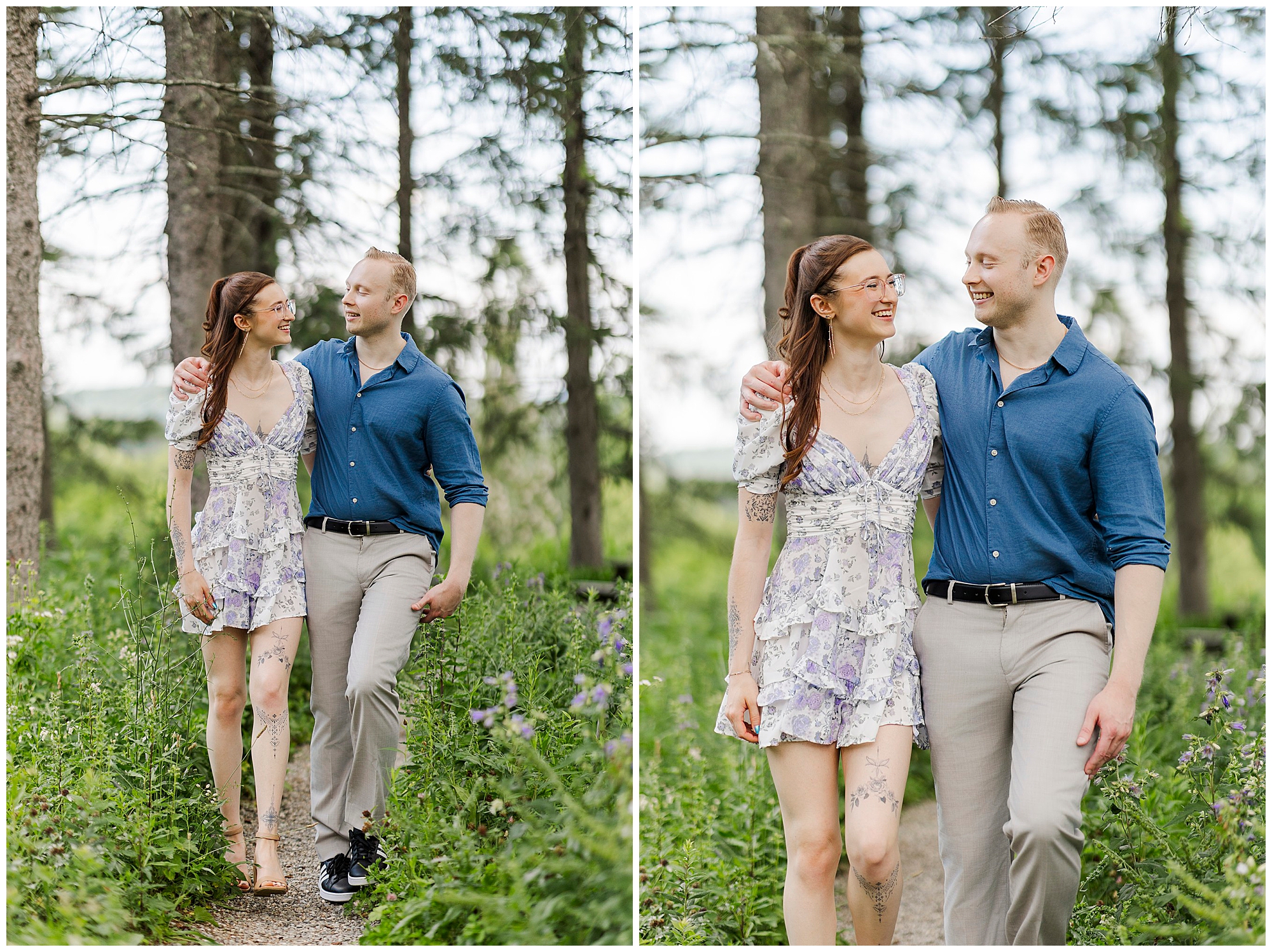 A couple walks together on a path through a green, wooded area for their engagement pictures at Stonecrop Gardens. Smiling at each other, the woman wears a floral dress and sandals, while the man wears a blue shirt with light pants and black shoes.