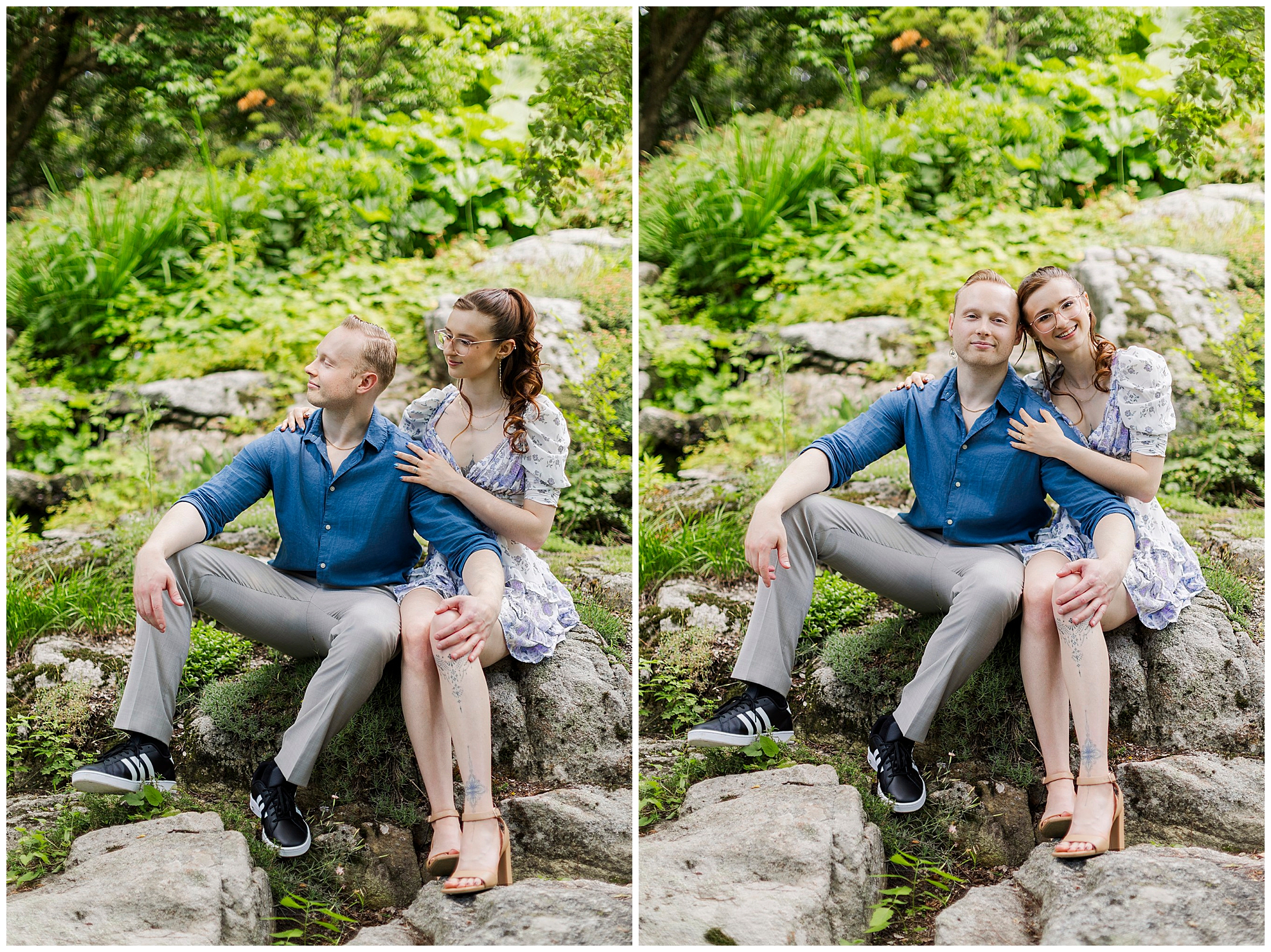 A couple sits on rocks in a lush garden for their engagement pictures at Stonecrop Gardens. The man is in a blue shirt and gray pants, while the woman in a floral dress smiles warmly, affectionately touching his shoulder.