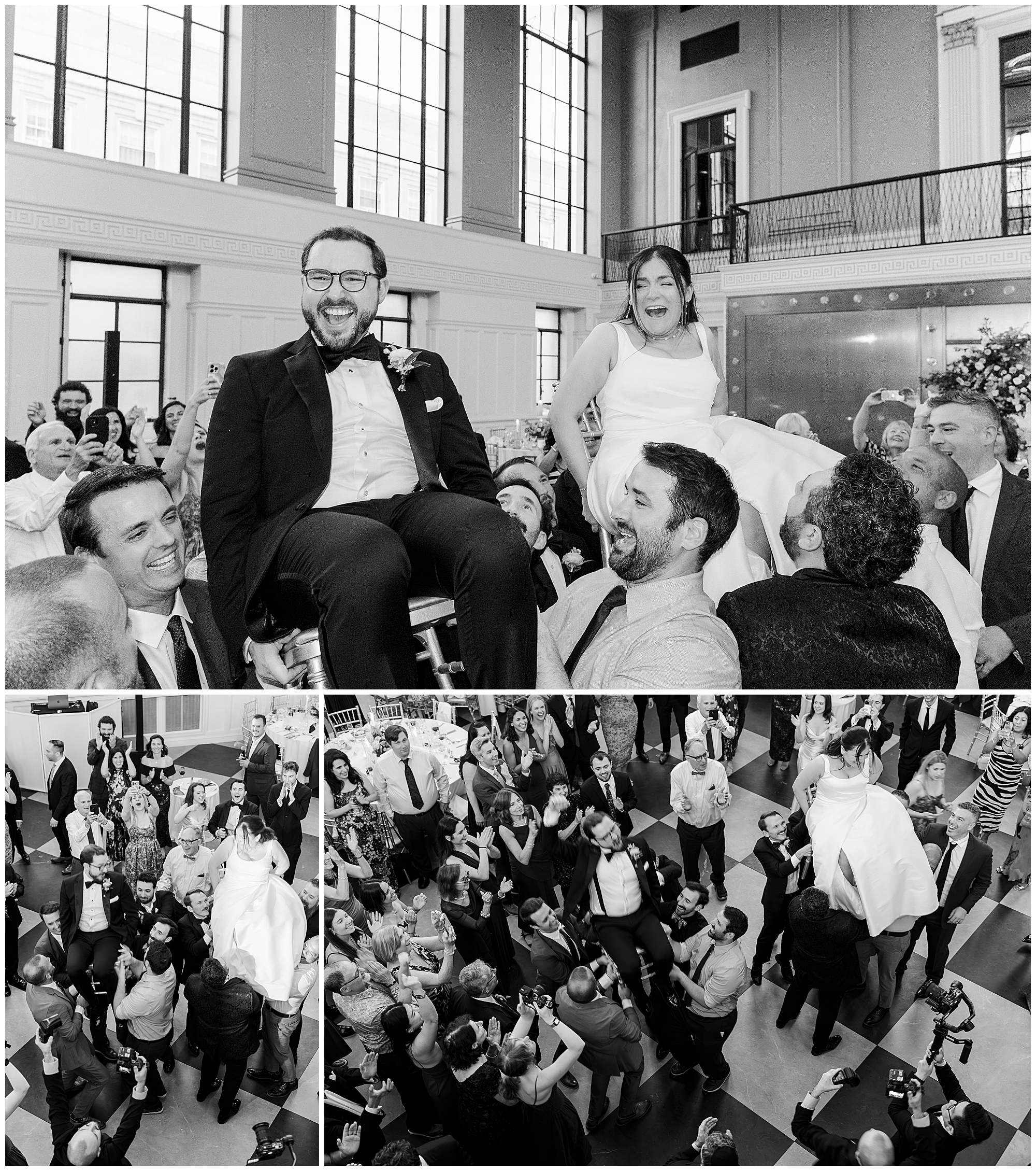 A bride and groom are lifted on chairs by guests during a lively felina wedding celebration in a grand hall. The couple smiles joyfully as people cheer around them.