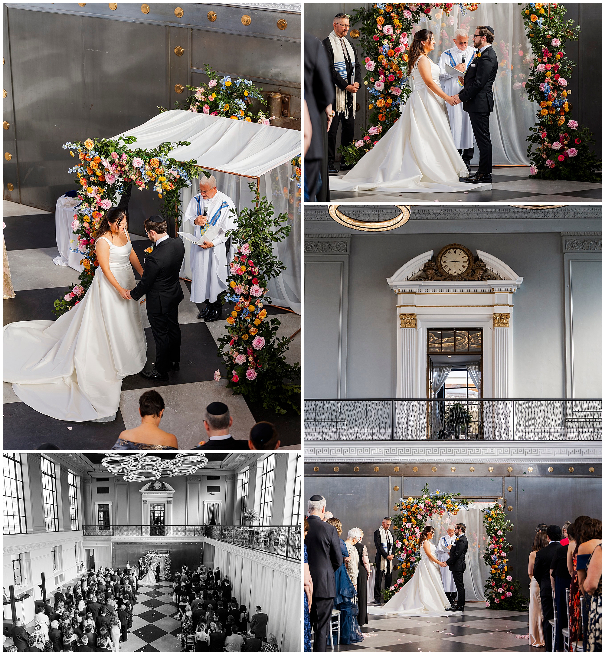 A bride and groom stand under a floral chuppah during their felina wedding ceremony, surrounded by guests and officiants in a grand, elegant indoor venue with high ceilings and classic architecture.