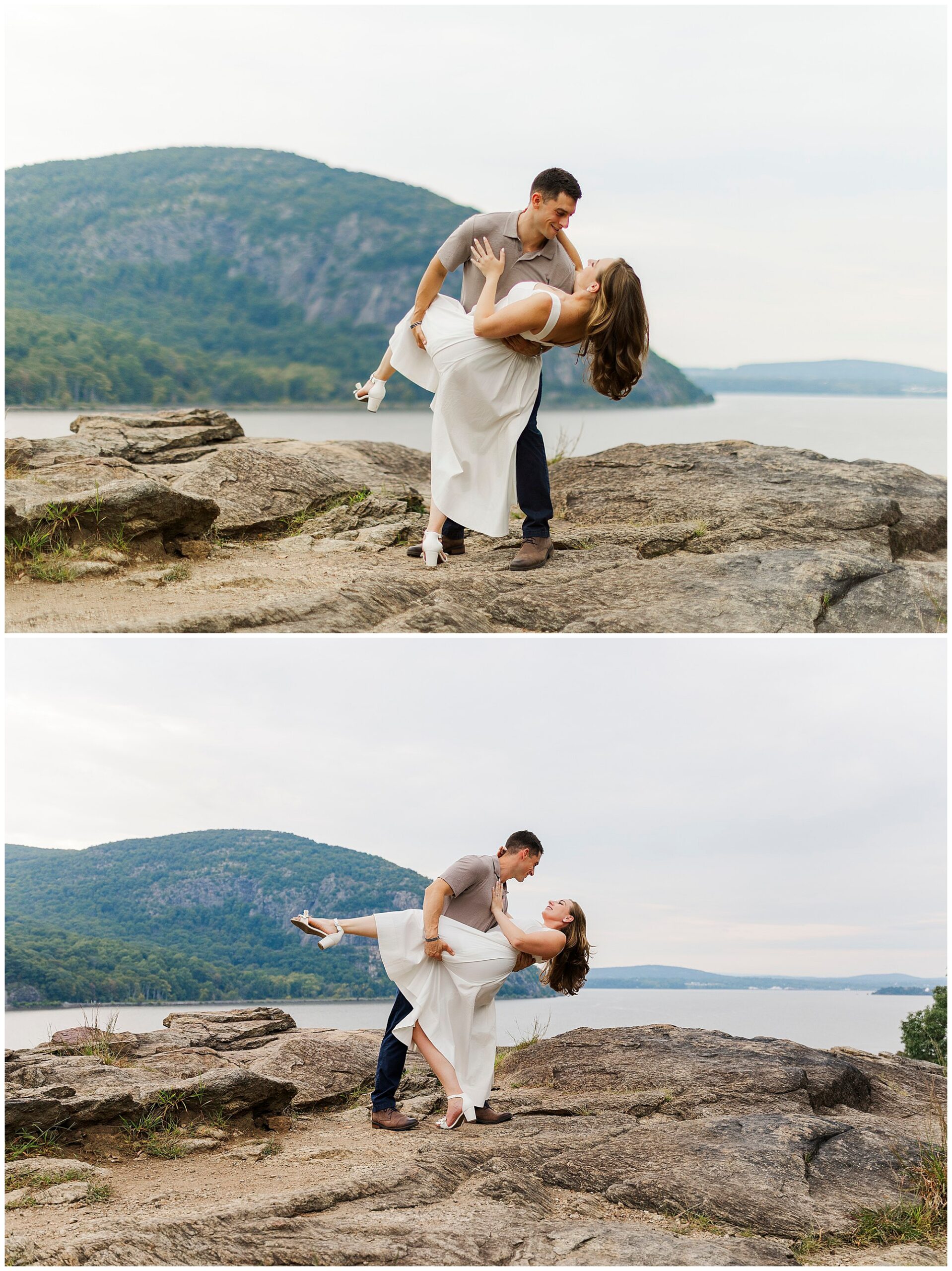 Man dips his smiling fiancee on the rocks by the water, with green hills in the background.