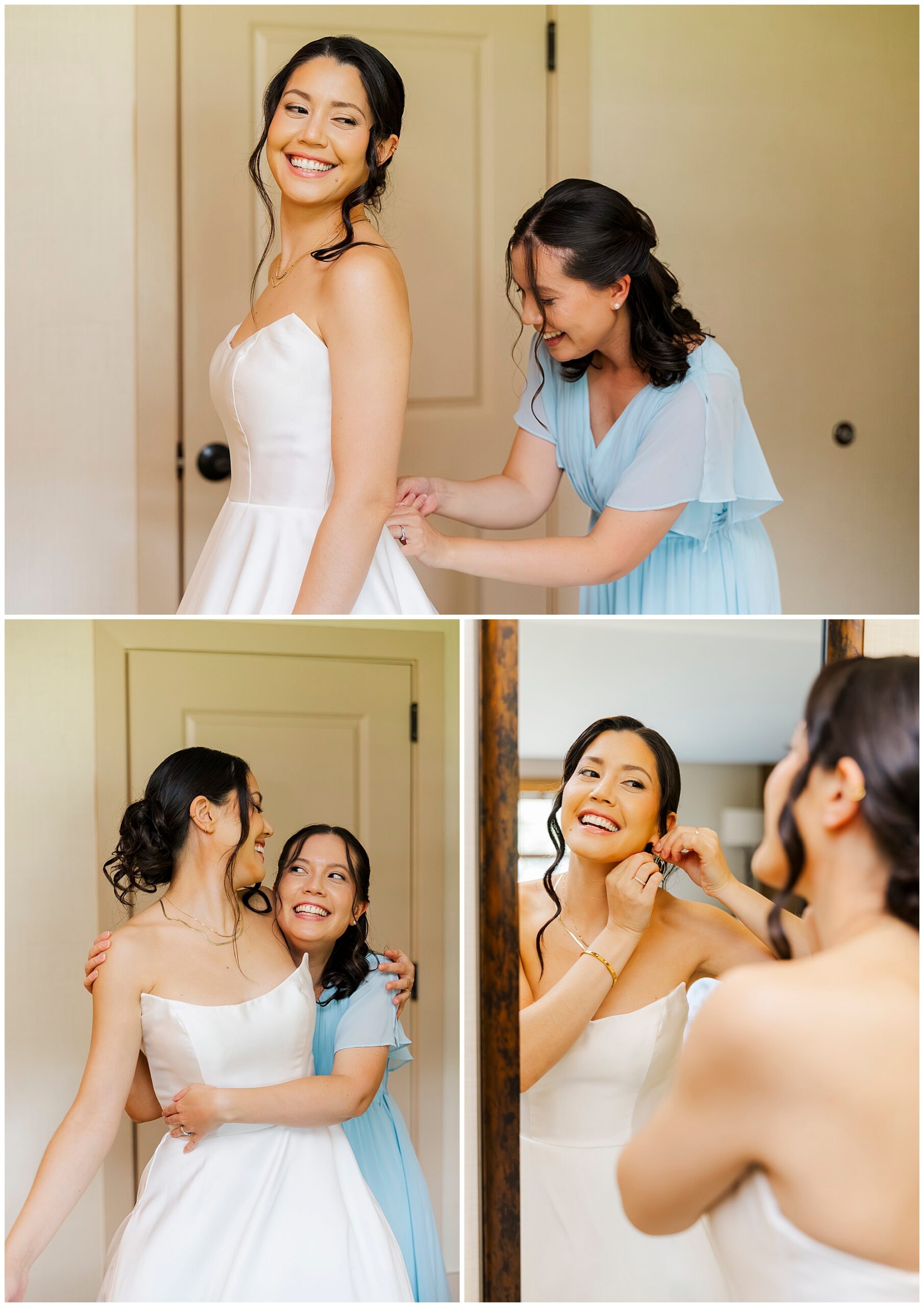 Woman in a light blue dress helps the smiling bride with her white gown and earrings in a softly lit room.