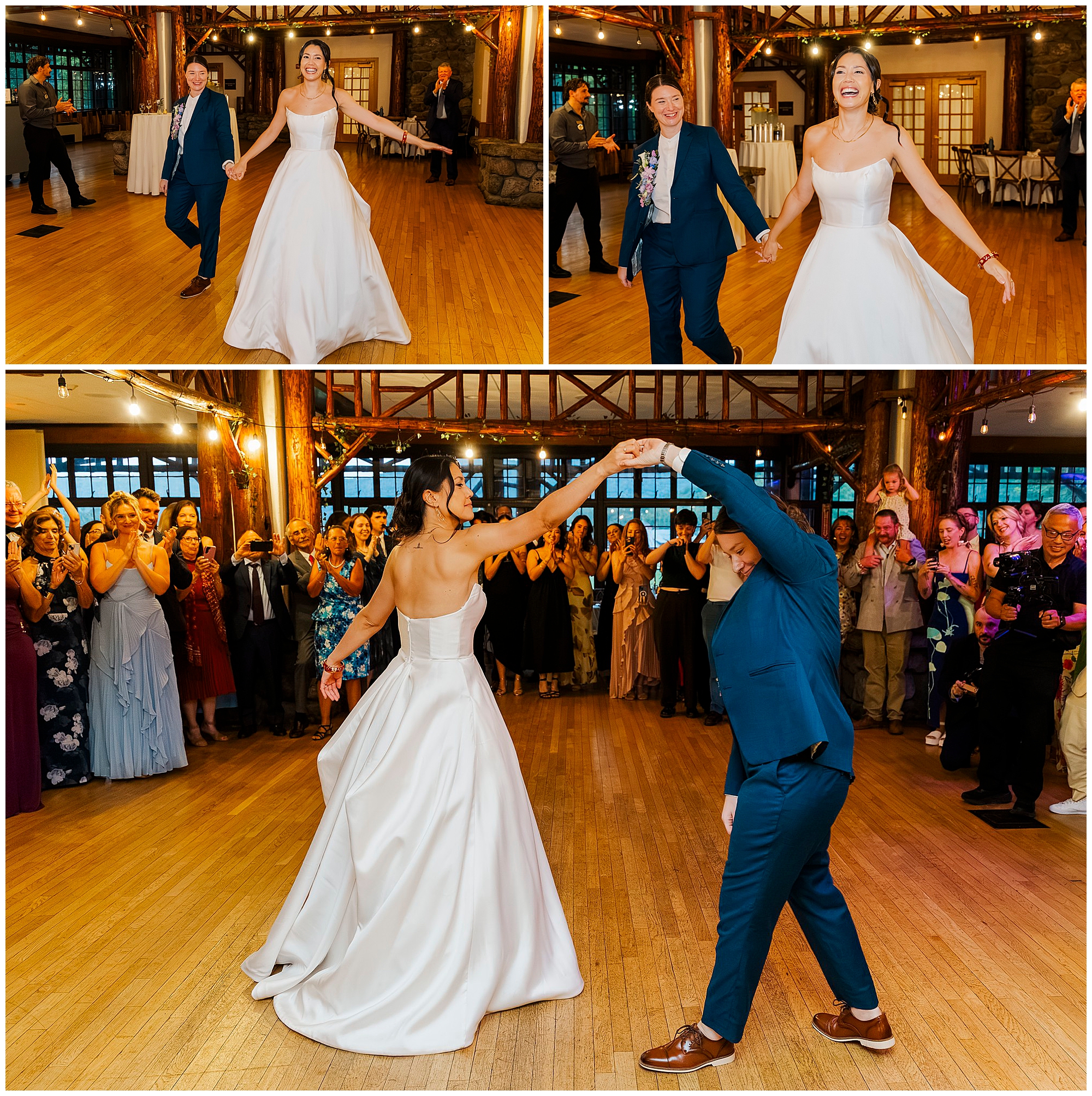 Bride in a white gown and bride in a blue suit dance together while smiling guests watch their first dance.
