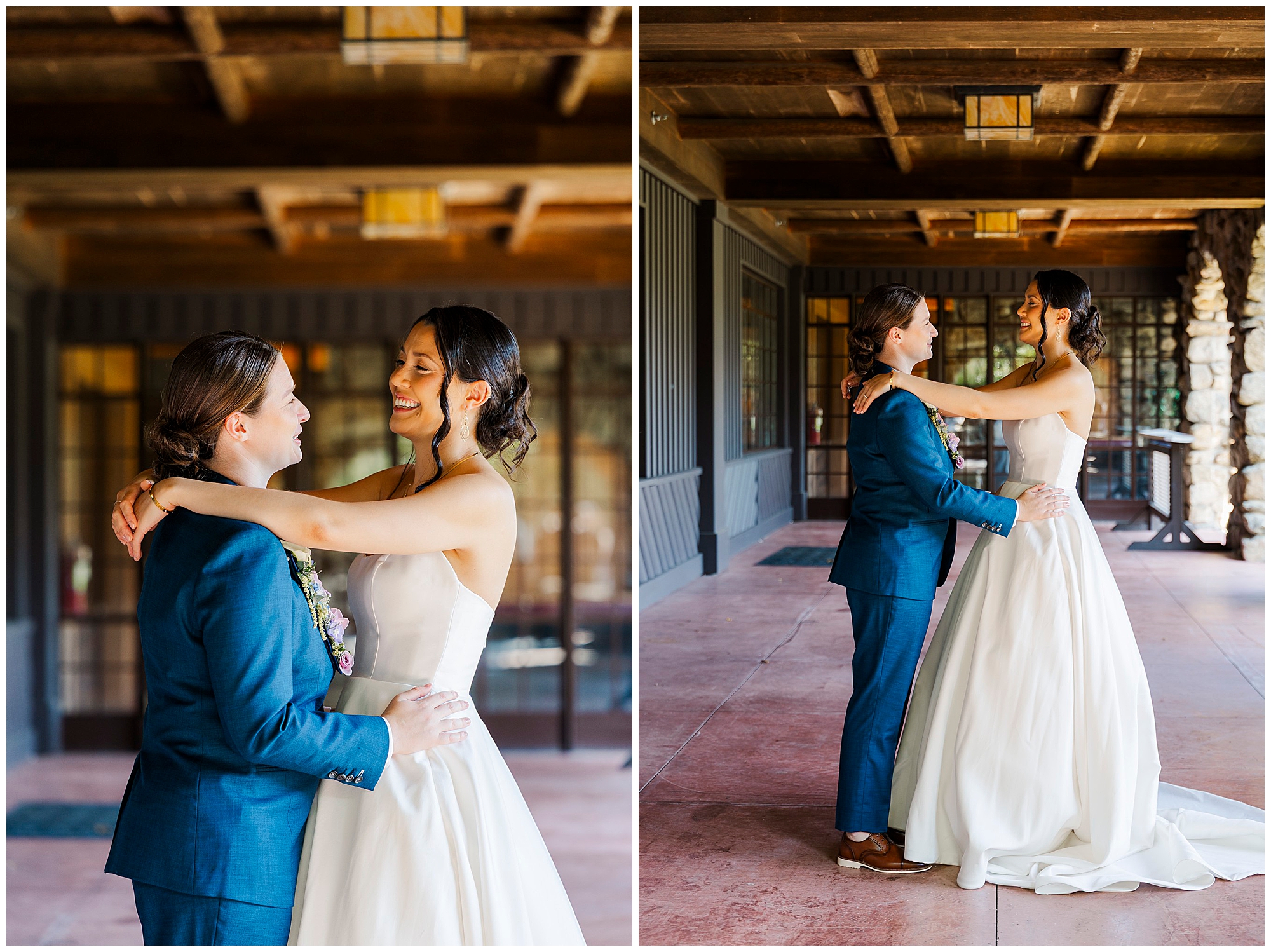 Two brides face each other and embrace on a rustic covered porch, one in a white strapless gown and one in a blue suit.