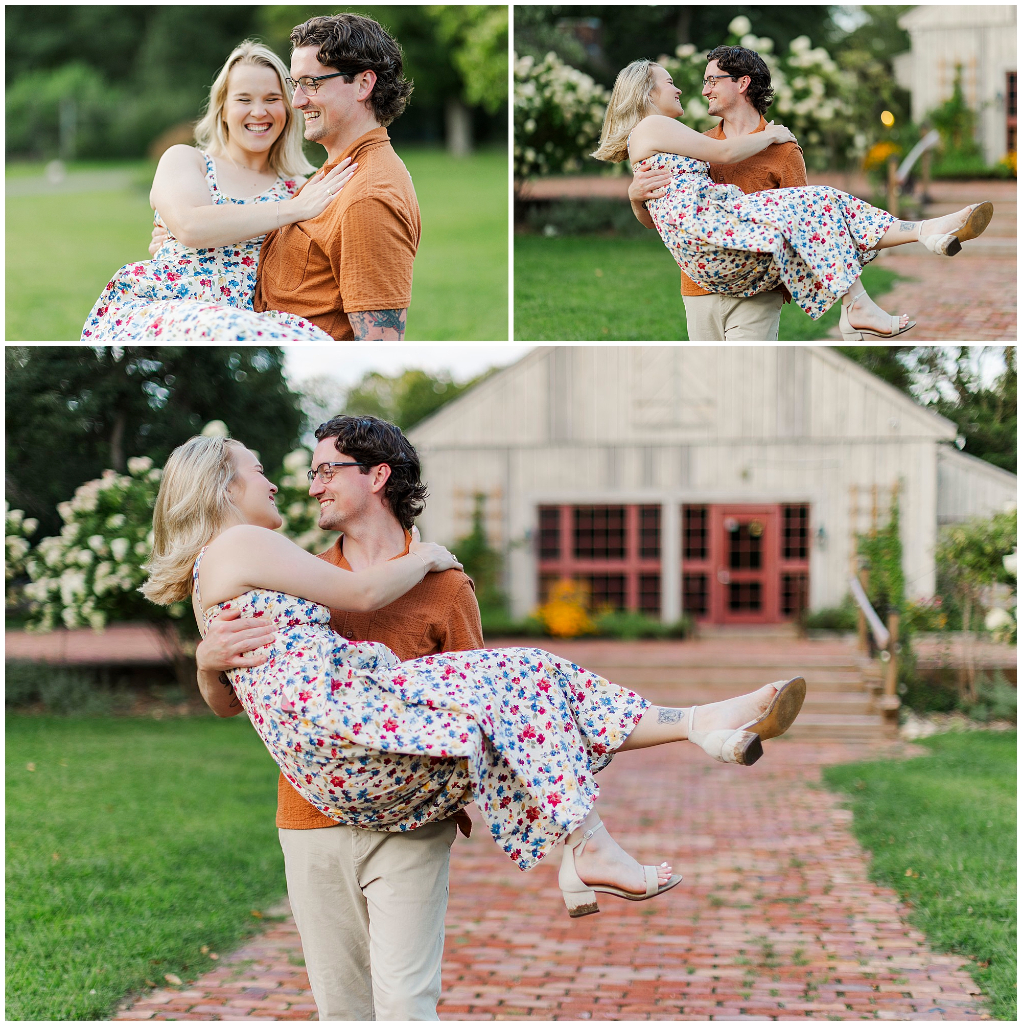 Man in an orange shirt lifts and carries a smiling woman in a floral dress, with a rustic barn and garden behind them.