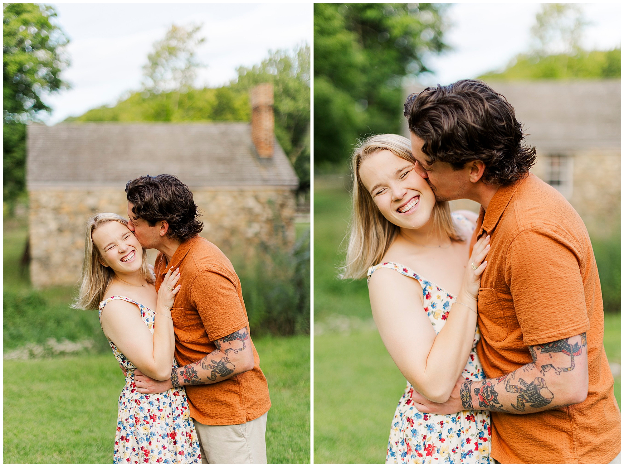 He kisses her cheek as she smiles, with a stone house and green trees behind them.