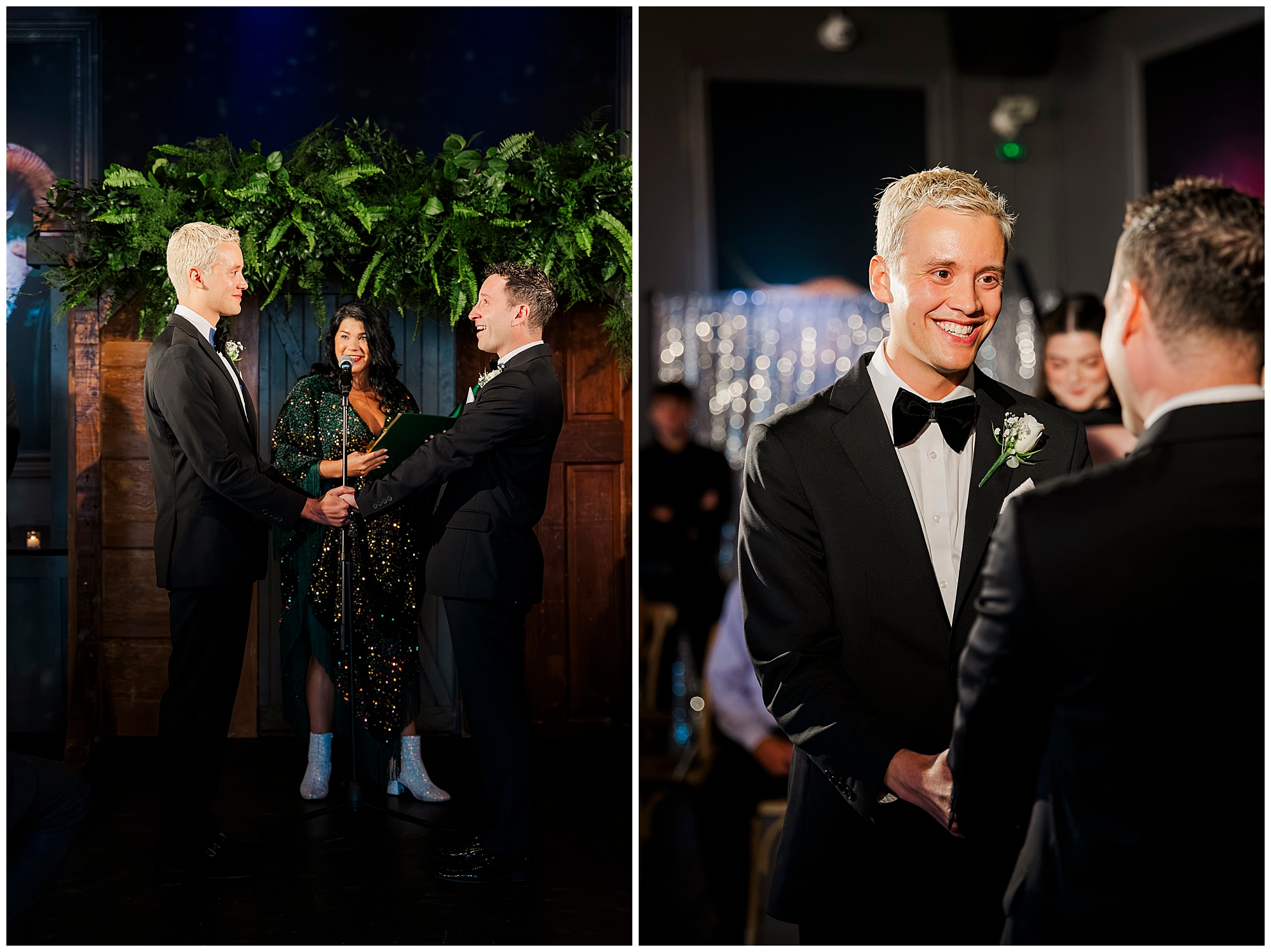 Two grooms in black tuxedos hold hands and smile at each other during their Porta Asbury Park wedding ceremony, with an officiant standing behind them and guests visible in the background.