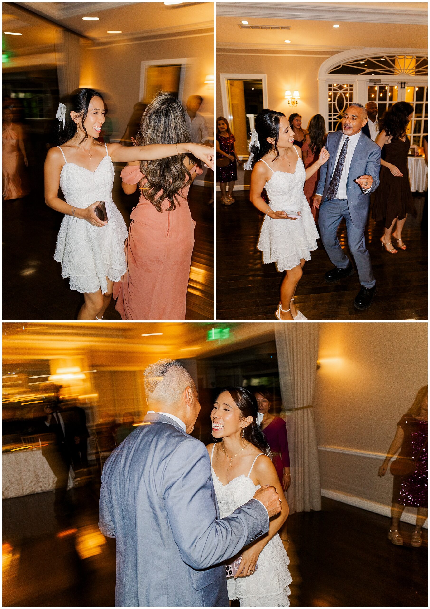 A woman in a white dress joyfully dances with guests at an indoor celebration. The room is warmly lit, and everyone appears happy, smiling, and engaged in the festivities. The image captures movement and laughter.