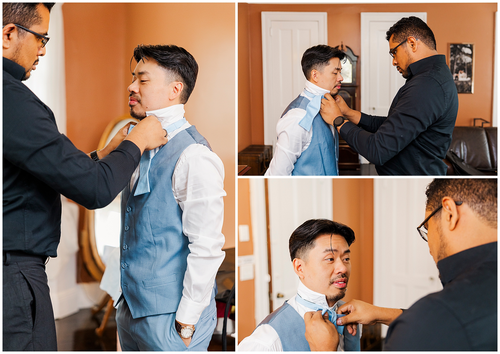 A man in a blue vest is helped by another man to adjust his tie in a warmly lit room, preparing for a formal event.