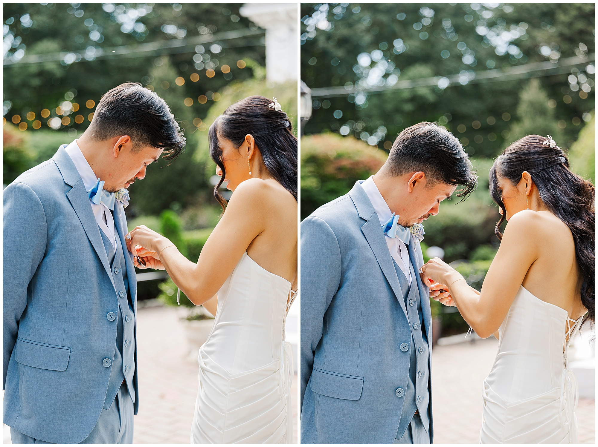 A bride in a strapless gown helps a groom in a light blue suit adjust his boutonniere outdoors. Both are smiling and focused on the task.