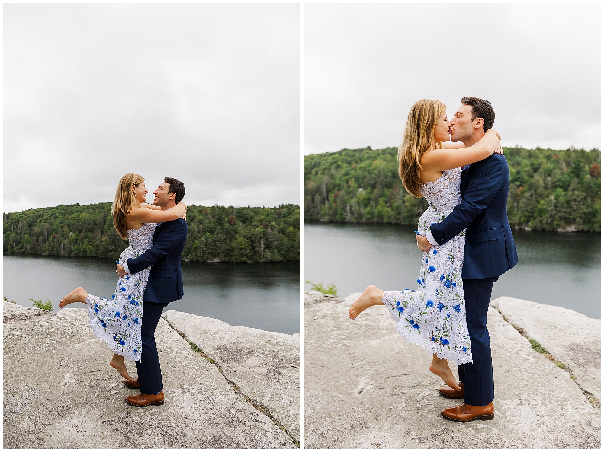 Groom lifts the laughing bride on a rocky cliff above the lake, with green trees and water behind them under a cloudy sky.