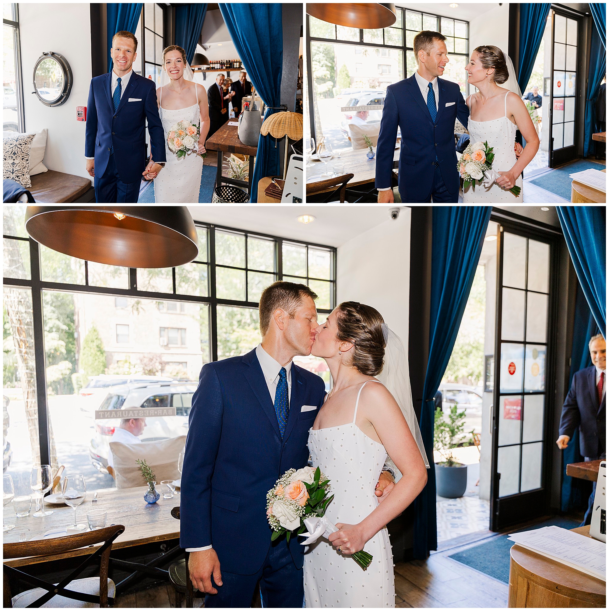 A bride and groom in wedding attire enter the bright Cafe Alaia, exchanging smiles and a kiss by large windows as they celebrate their micro-wedding, holding a bouquet of flowers.