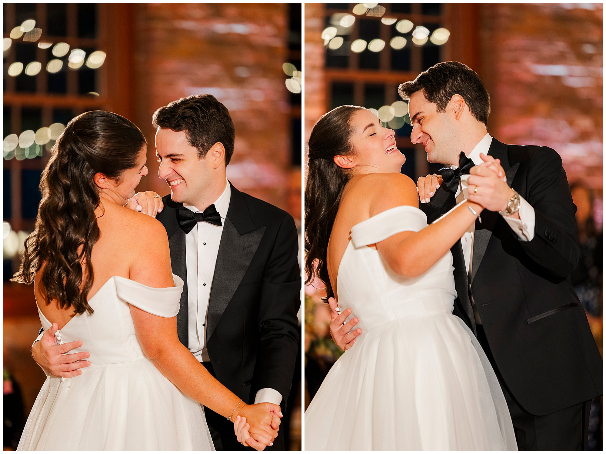 A bride and groom in formal wedding attire joyfully dance together, smiling and holding hands in a warmly lit venue with blurred lights in the background.